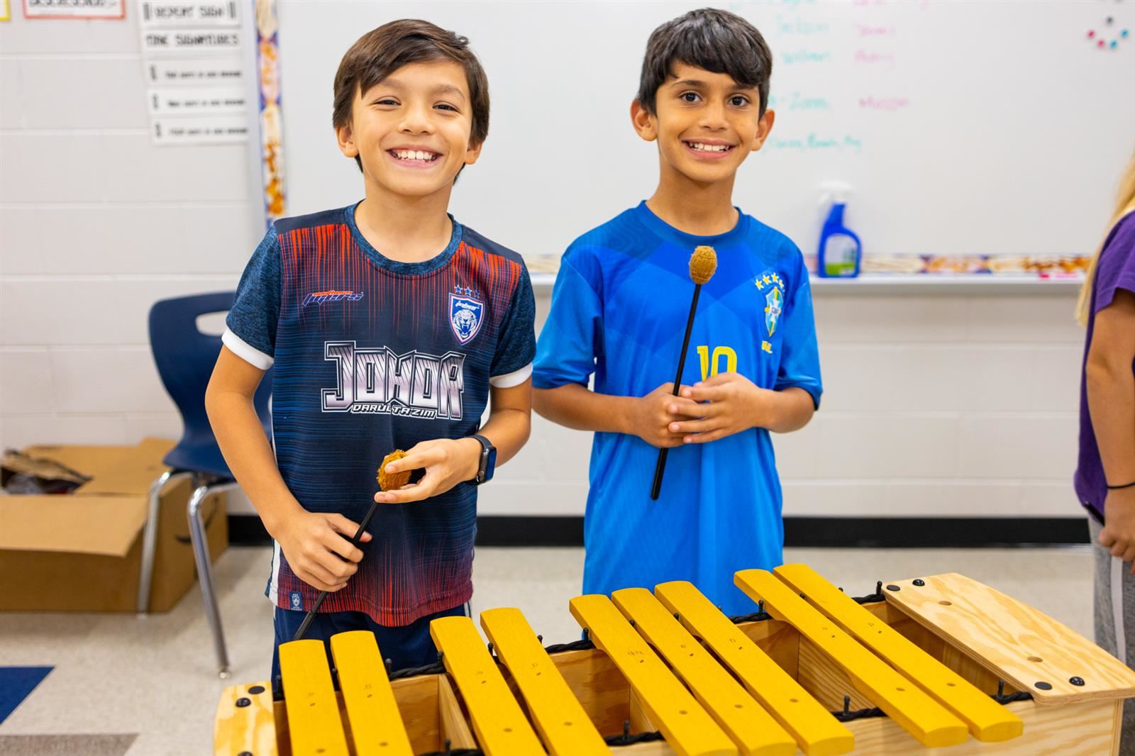 Two boys playing musical instruments